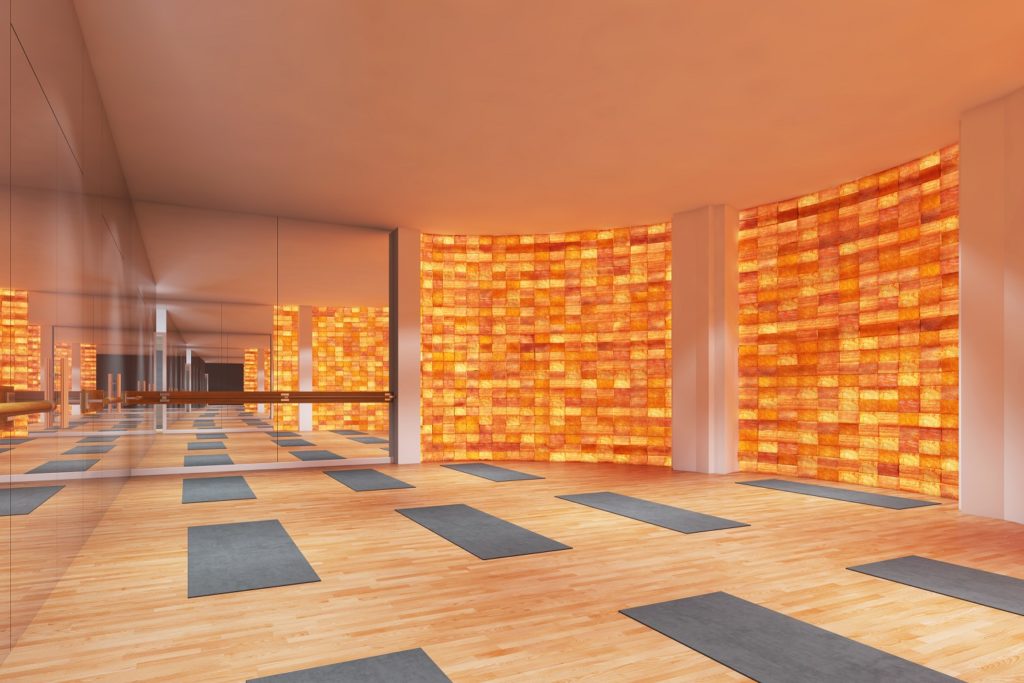 Movement Studio with backlit Himalayan Rock Salt wall emitting negative ions to enhance benefits of yoga, TaiChi and QiGong. This multi-purpose space will also host dance classes and ping pong games.